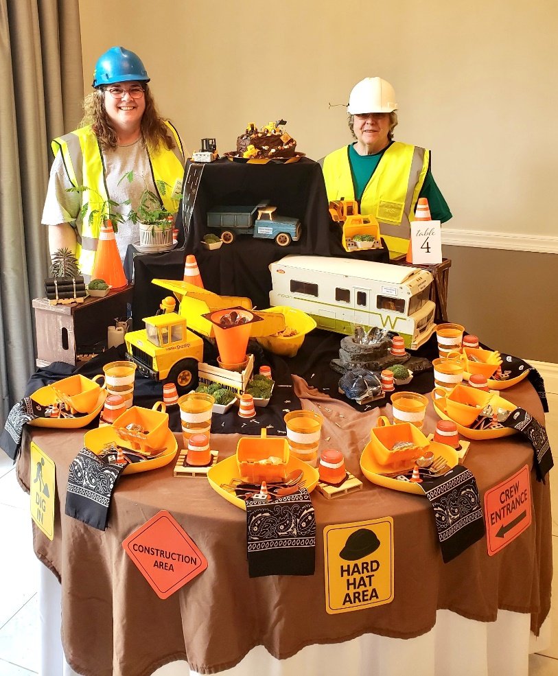 Celebrating their first-place win at TABLESCAPES 2024 in Avon are Renee Holder, and her mother, Rose Bennett who wore hard hats to coordinate with their Table “If You Can Dream It, You Can Build It.”