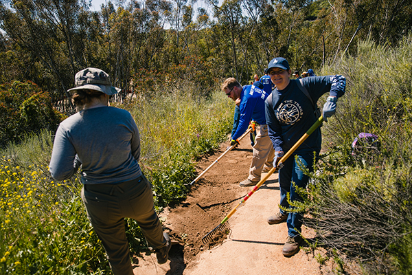 Athletic Brewing Co employees cleaning up a hiking trail photo via Athletic Brewing Company 