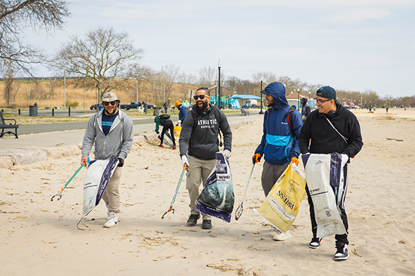 Athletic Brewing Co employees cleaning up a Connecticut beach 