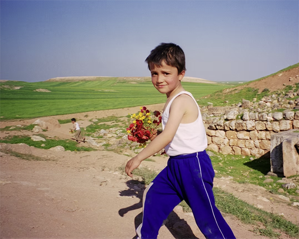 Boy with Flowers, Ebla, Syria by Alice Laurenson – IMAGES 2024