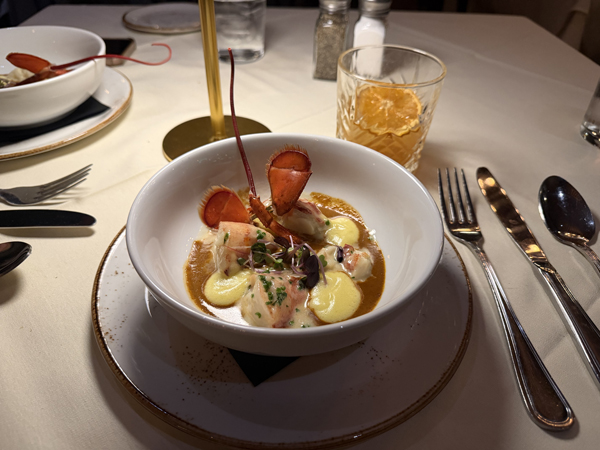 Amuse-bouche: butter-poached Maine lobster in star anise sauce with lemon sabayon. at The waveny tavern in New Canaan, Connecticut