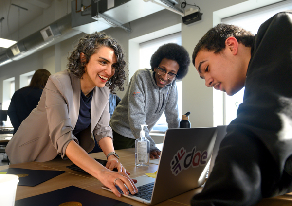 dae students Musa Khalif (center) and Keith Foster (right) showcase their work to IBM Quantum Ambassador Dr. Faezeh Gholami. Photo credit: Joel Callaway.