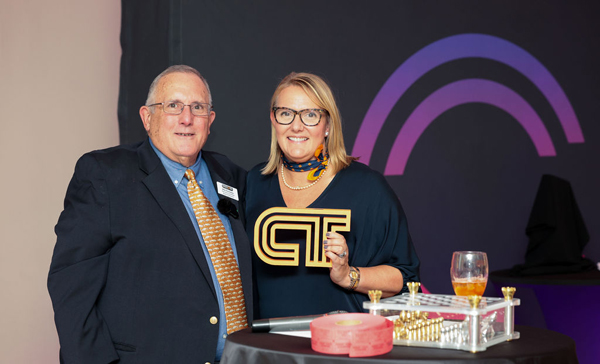 CEO Nicole Russo (right) of Microboard receives ManufactureCT’s Longevity Award, recognizing 20 years of membership in the organization, from Mike Rocheleau, ManufactureCT board president (left).